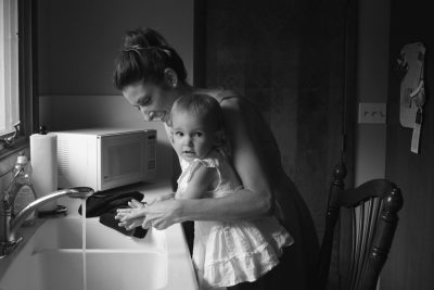 Mother washing child's hands