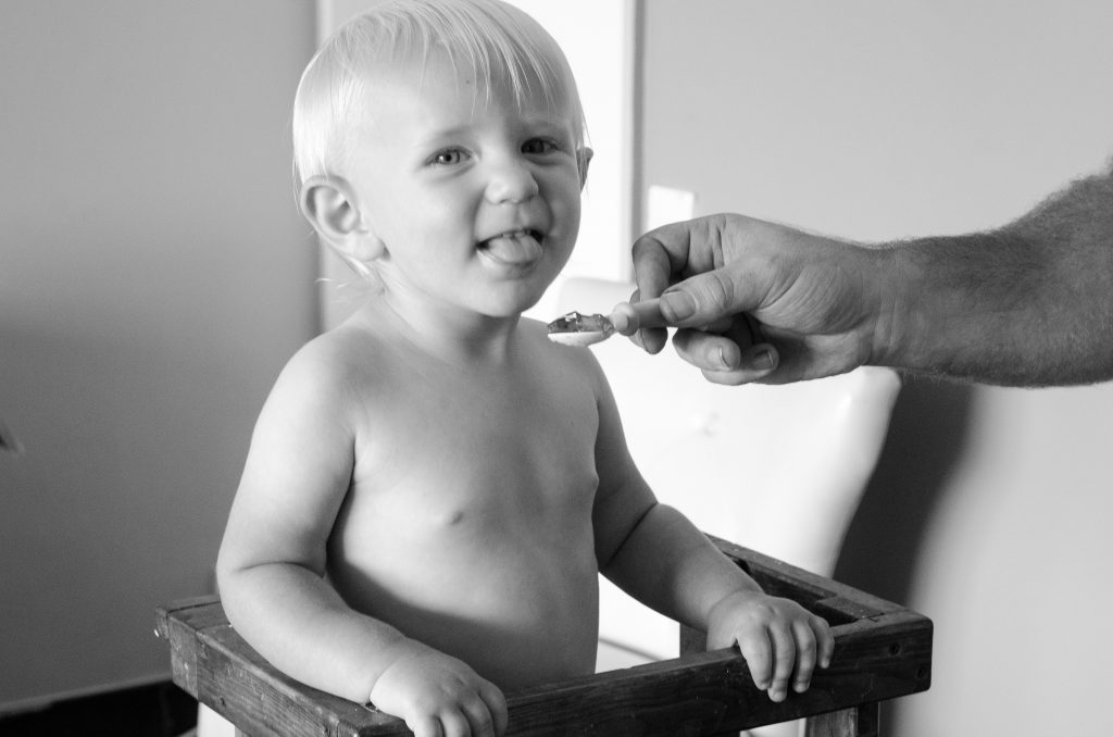 Toddler tasting Jello for the first time. 